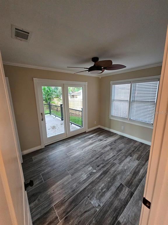A kitchen with white cabinets and a built-in corner hutch viewed from a dining area — 1277 17TH STREET, SARASOTA, FL