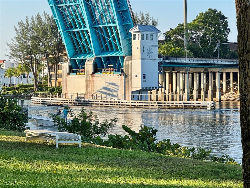 A raised drawbridge stands over a waterway with a small boat passing beneath it — 304 GOLFVIEW ROAD UNIT PH, NORTH PALM BEACH, FL