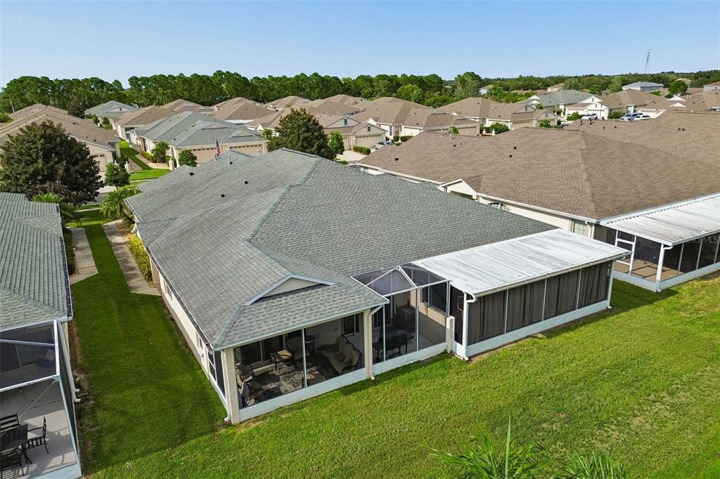 An aerial view shows a suburban house with a screened-in patio and a shingled roof — 11435 CAMBRAY CREEK LOOP, RIVERVIEW, FL