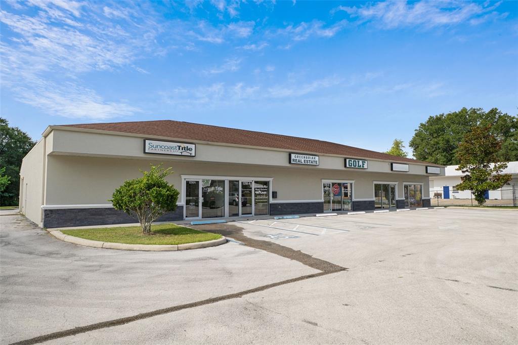 A single-story commercial building with multiple storefronts and a paved parking lot in front — 1298 E NORVELL BRYANT HIGHWAY UNIT D, HERNANDO, FL