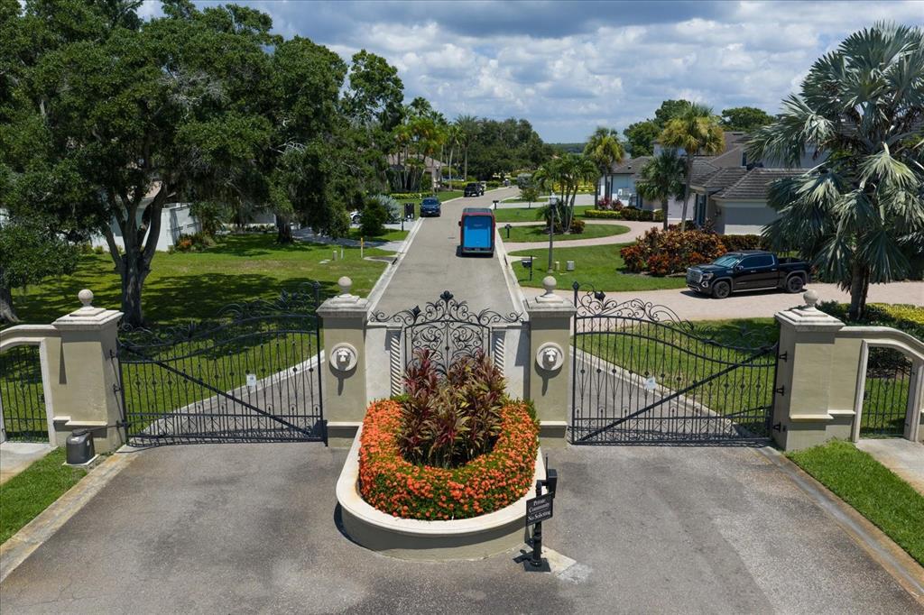 An aerial view of a gated entrance to a residential community with lush landscaping — 0 BLACKSTONE DRIVE, PALM HARBOR, FL