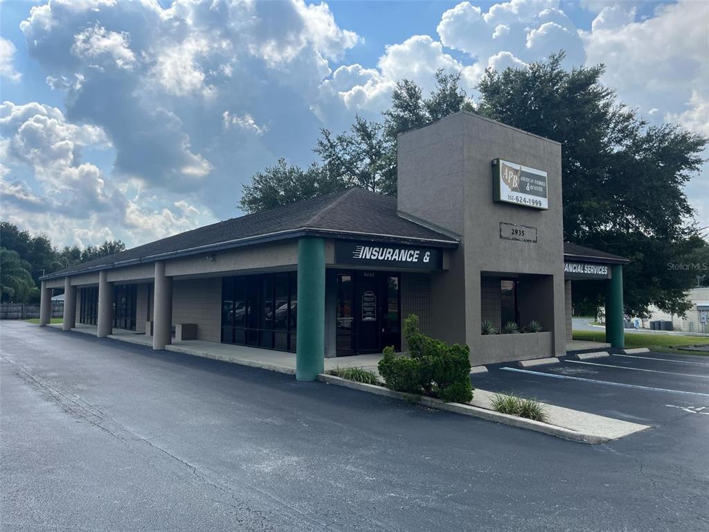 A single-story commercial building with a brown stucco exterior and a parking lot — 2935 SE 58TH AVENUE, OCALA, FL