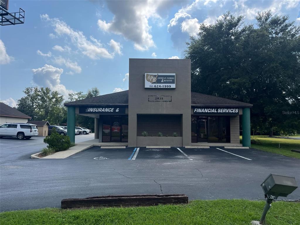 A single-story commercial building with a parking lot and signage for American Payroll & Benefits — 2935 SE 58TH AVENUE, OCALA, FL