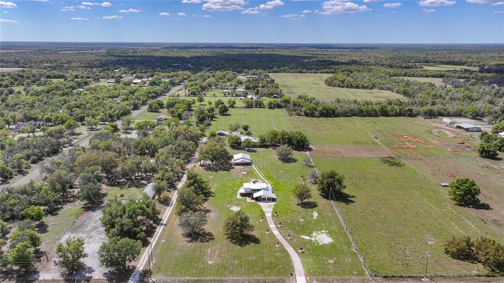 An aerial view shows a house with a long driveway surrounded by large grassy fields — 3049 SW COUNTY ROAD 769, ARCADIA, FL