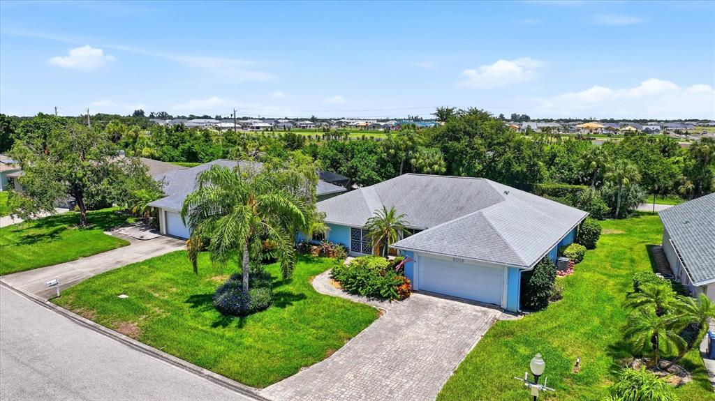 An aerial view of a single-story house with a gray roof and a paved driveway — 5015 86TH STREET COURT W, BRADENTON, FL