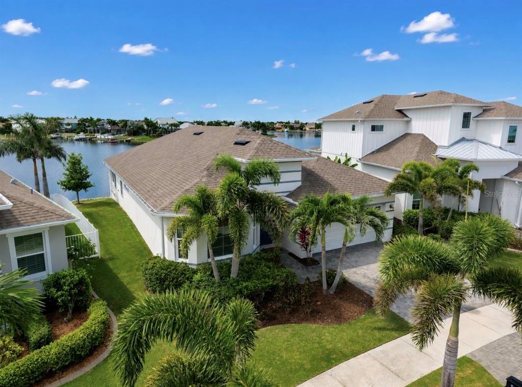 An aerial view of a single-story house with a brown roof near a canal — 5347 WISHING ARCH DRIVE, APOLLO BEACH, FL