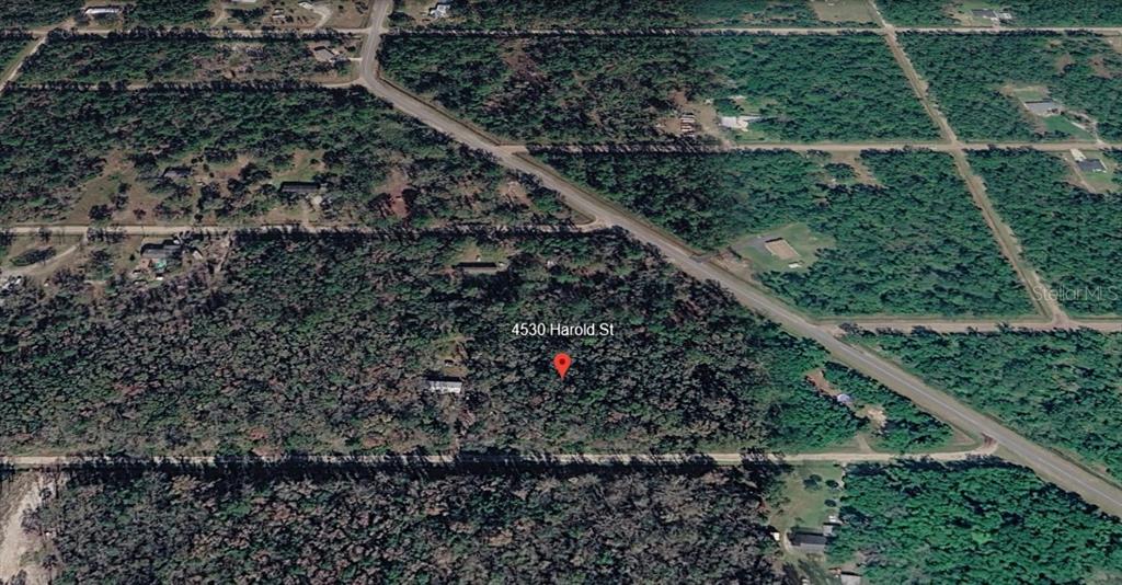 This is an aerial map view showing a wooded lot with a red location pin — 4530 HAROLD STREET, HASTINGS, FL