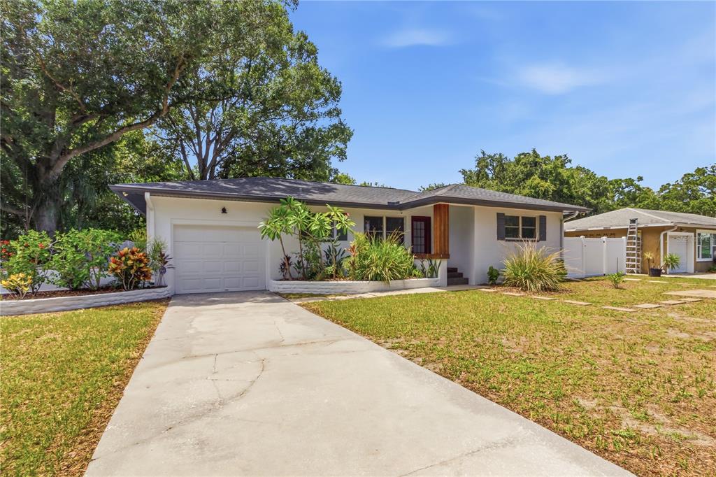 A single-story house with a white exterior, a garage, and a concrete driveway — 10 S ORION AVENUE, CLEARWATER, FL