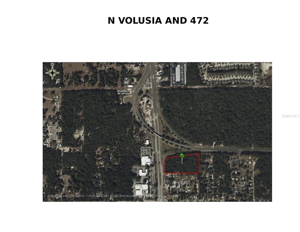 This is an aerial map showing a vacant, wooded parcel of land outlined in red — N VOLUSIA AVENUE, ORANGE CITY, FL