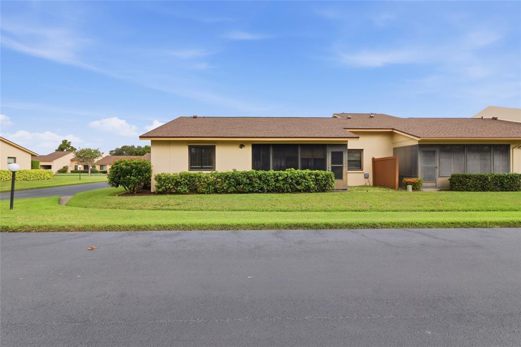 A single-story residential building with a screened-in porch and a tan exterior — 3191 GLEN ELYN BOULEVARD UNIT 4, SARASOTA, FL