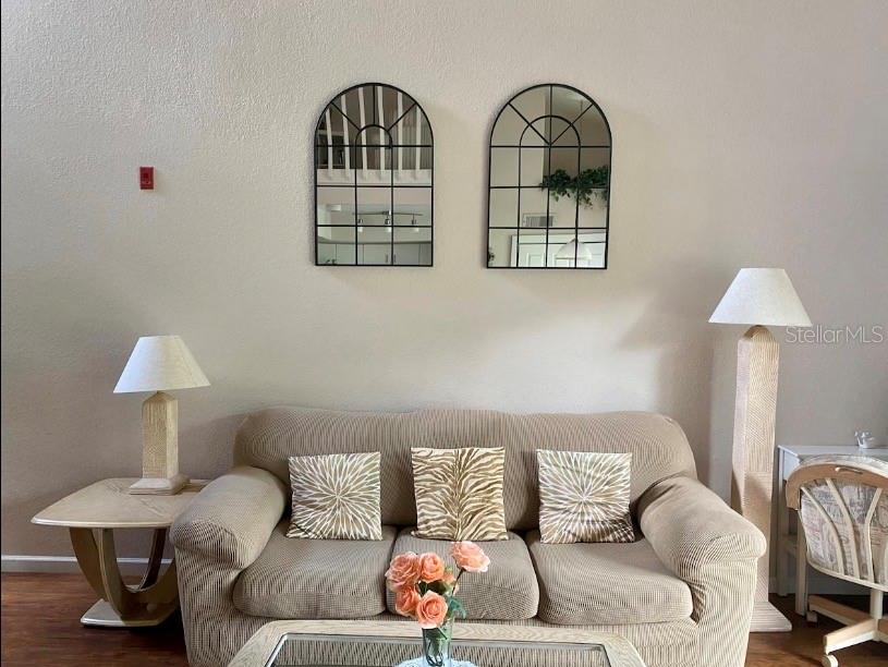 A living room features a beige sofa, two arched wall mirrors, and two floor lamps — 3161 TAMARIND CIRCLE, KISSIMMEE, FL