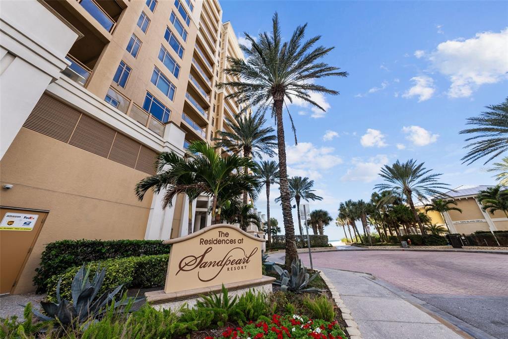 A sign for The Residences at Sandpearl stands before a tall building and palm trees — 470 MANDALAY AVENUE UNIT 303, CLEARWATER, FL