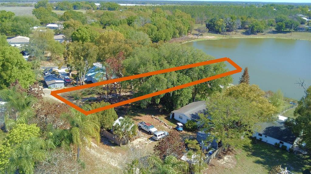 An aerial view shows a rectangular lot outlined in orange bordering a lake — 0 CENTRAL AVENUE, BARTOW, FL