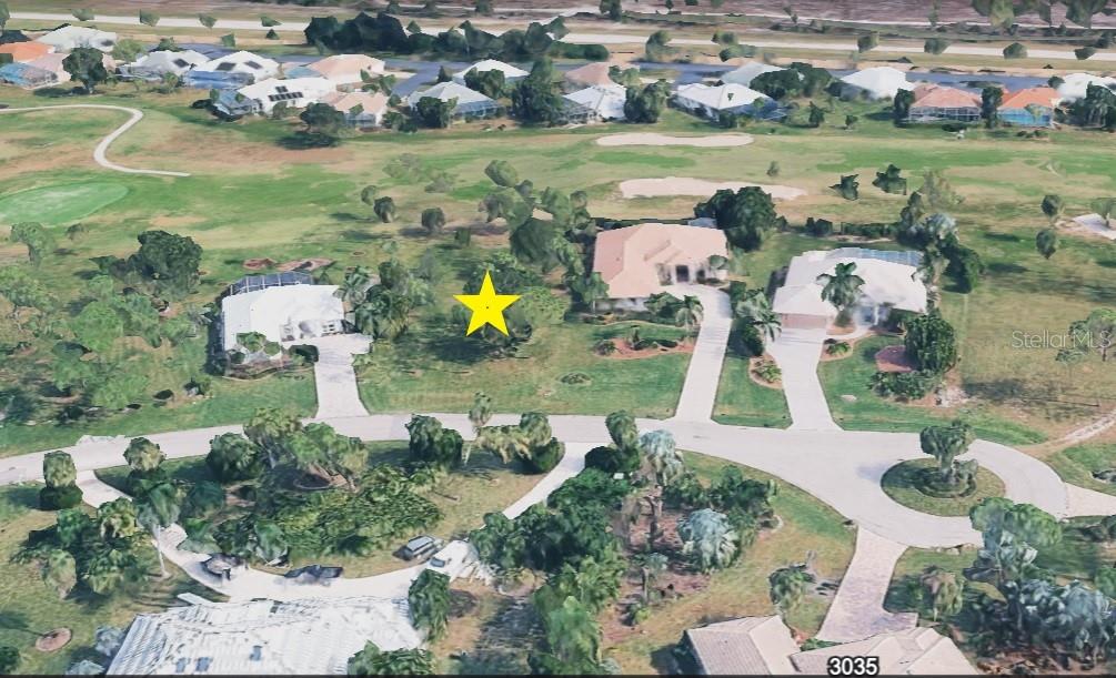 An aerial view shows a vacant lot marked with a yellow star between two houses — 3030 BIG BEND CIRCLE, PUNTA GORDA, FL