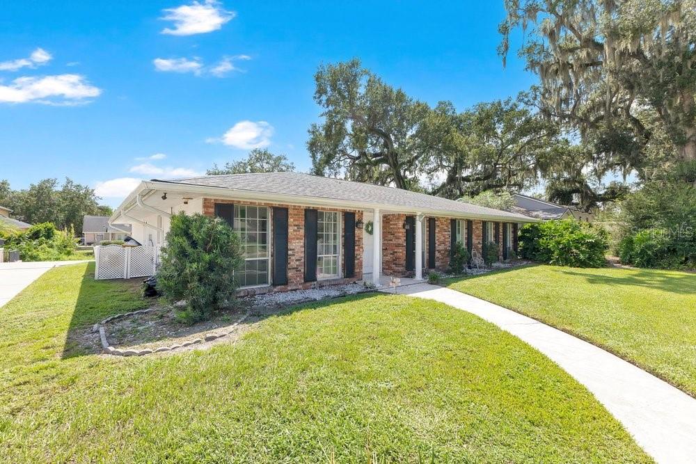 A single-story brick house with a white roof and a front walkway on a lawn — 460 HARBOUR ISLAND ROAD, ORLANDO, FL