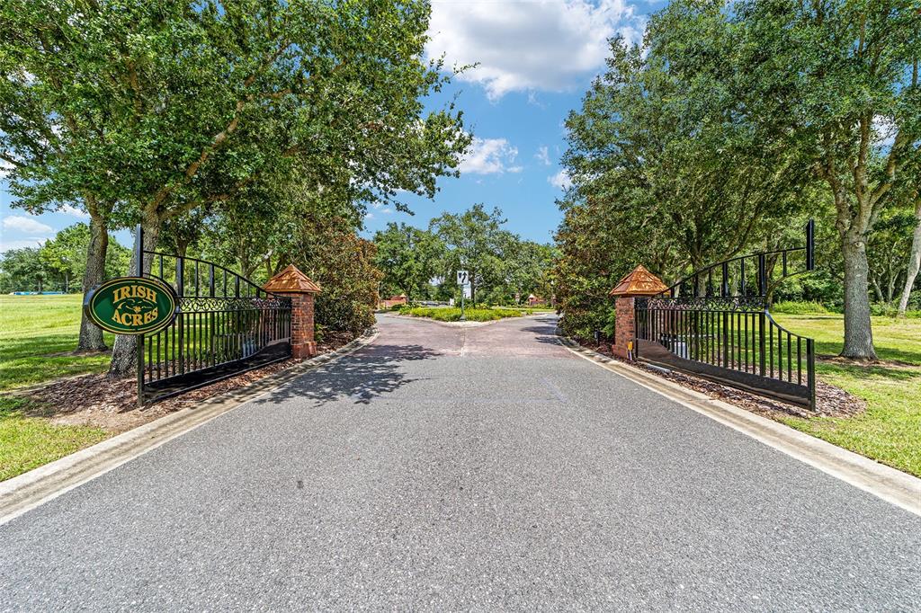 An open wrought iron gate marks the entrance to a residential community named Irish Acres — 1929 NW 85TH LOOP, OCALA, FL