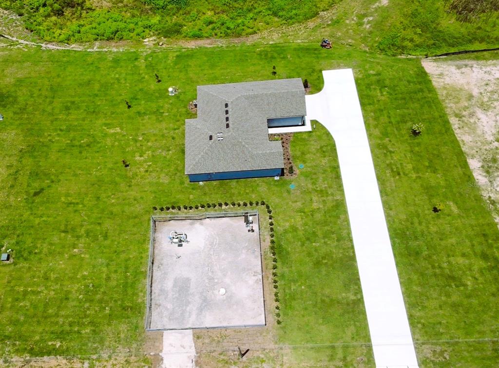An aerial view shows a house with a long driveway and a fenced-in dirt area — 2426 HIERS ROAD, DOVER, FL