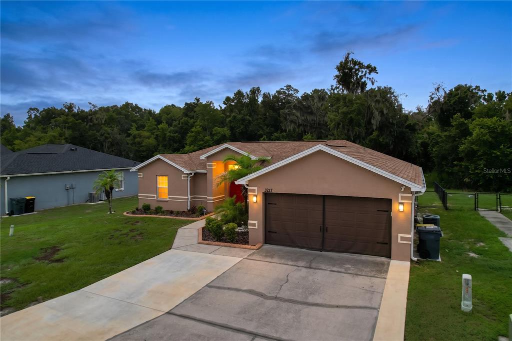 A bathroom features a double vanity with wood cabinets, a soaking tub, and a shower — 3217 ENCLAVE BOULEVARD, MULBERRY, FL