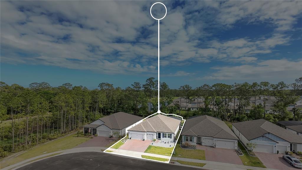 An aerial view shows a single-story suburban house with a two-car garage and driveway — 3160 FIRETHORN CIRCLE, DAYTONA BEACH, FL