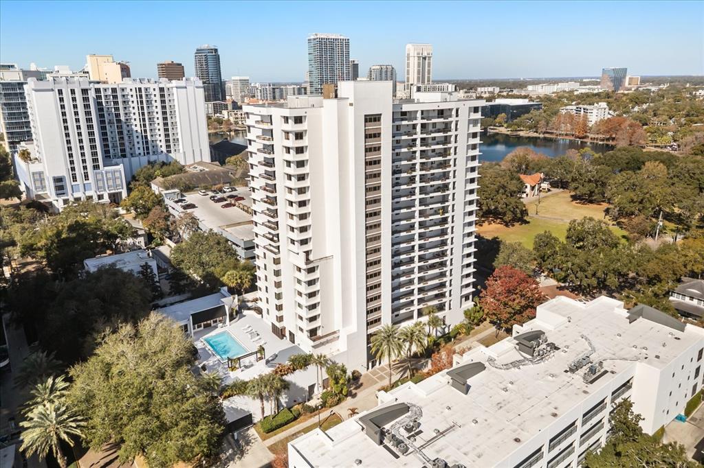 An aerial view shows a tall white apartment building with a pool and parking garage — 530 E CENTRAL BLVD UNIT 1901, ORLANDO, FL