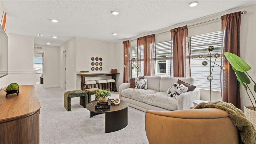 A living room features a beige sofa, a round coffee table, and a console table — 3116 ROCKWOOD WAY, MINNEOLA, FL