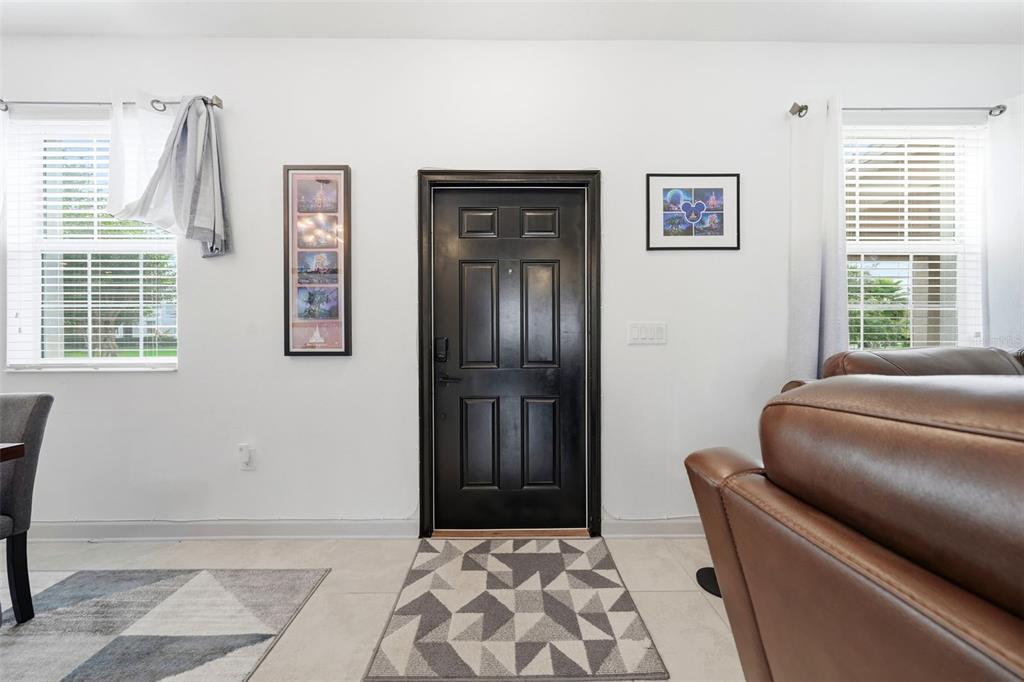 A front entryway features a black door, tiled floors, and two windows with white blinds — 11025 SUSPENSE DRIVE, WINTER GARDEN, FL