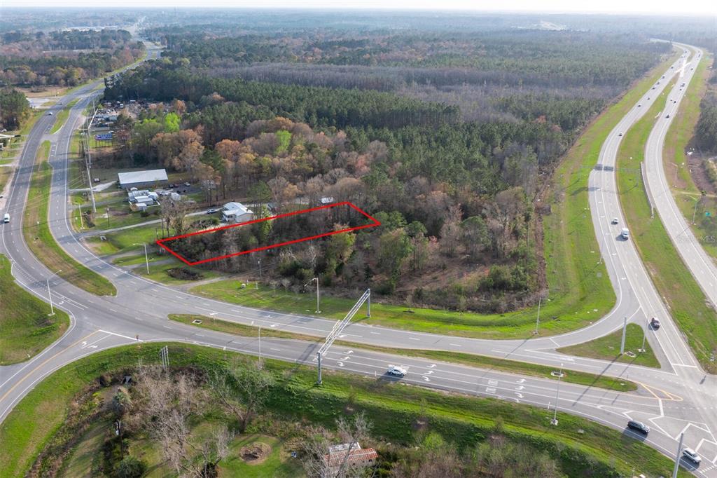 An aerial view shows a rectangular plot of land outlined in red near a highway — N HYW 301, STARKE, FL