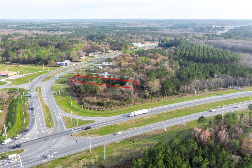 An aerial view shows a rectangular plot of land outlined in red near a highway — N HYW 301, STARKE, FL