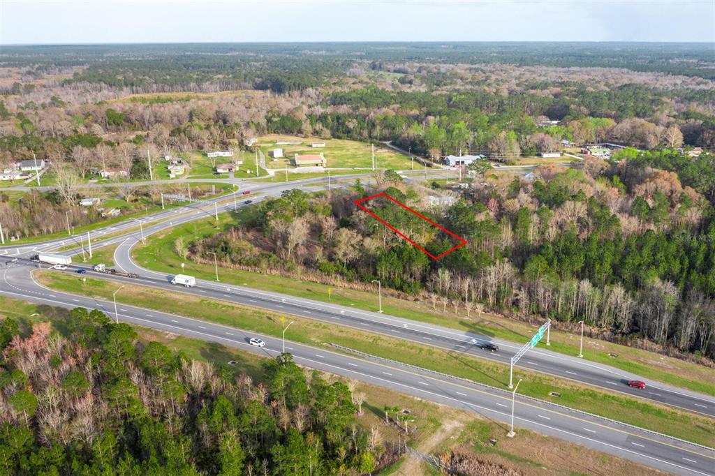 An aerial view shows a rectangular plot of land outlined in red near a highway — N HYW 301, STARKE, FL