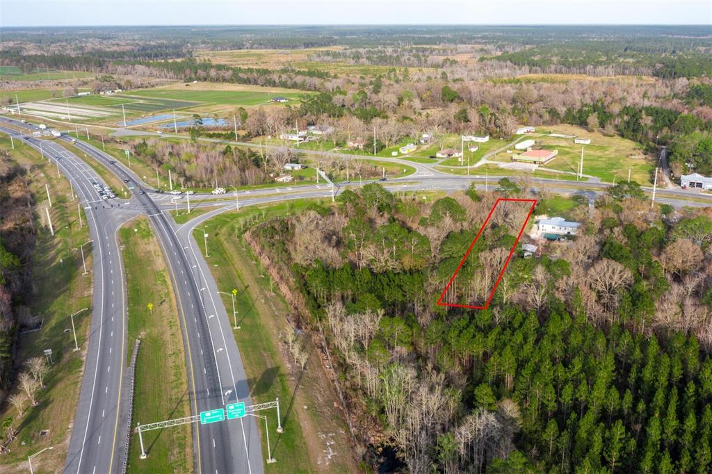 An aerial view shows a rectangular plot of land outlined in red near a highway — N HYW 301, STARKE, FL