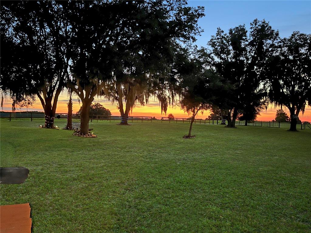 A single-story manufactured home with light siding, a front porch, and a paved walkway — 12651 SE COUNTY ROAD 337, DUNNELLON, FL