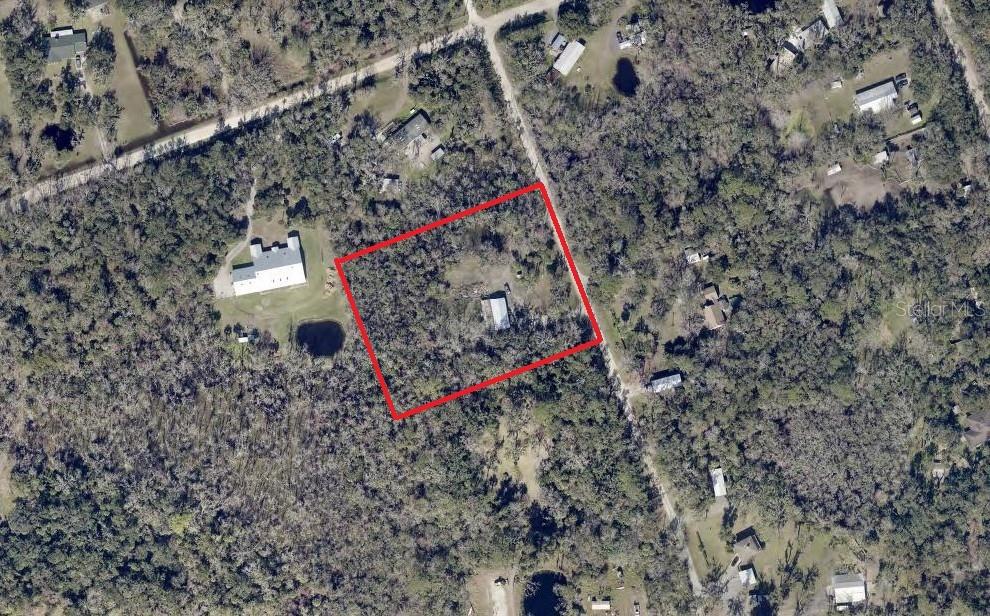 This aerial map shows a rectangular property boundary highlighted in red over a wooded lot — 1550 BOYCE CIRCLE, EDGEWATER, FL