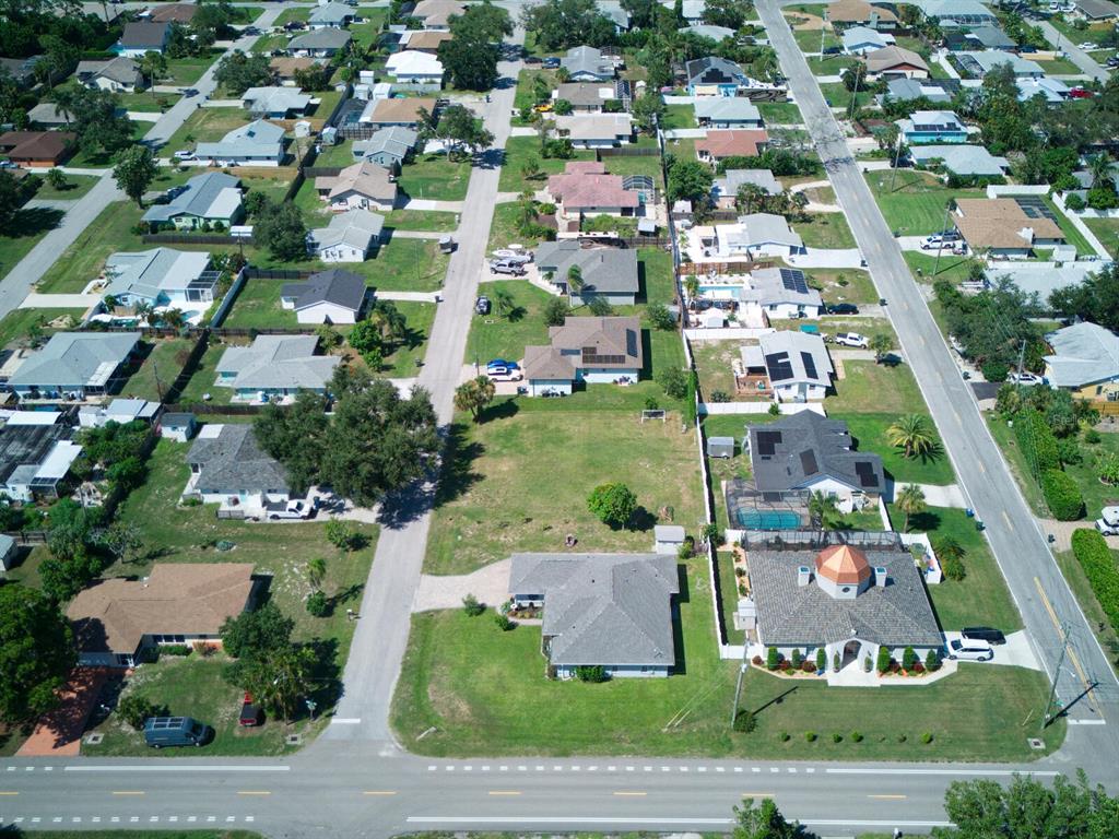 An aerial view shows a residential neighborhood with single-family homes, paved streets, and green lawns — 0 KIMBALL ROAD, VENICE, FL
