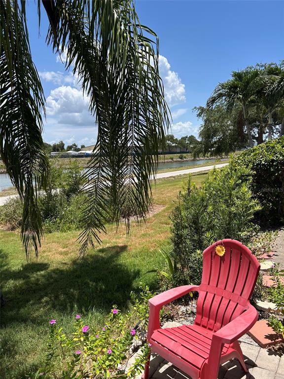 A pink house with a red tile roof and two palm trees in the yard — 210 RIO TERRA, VENICE, FL