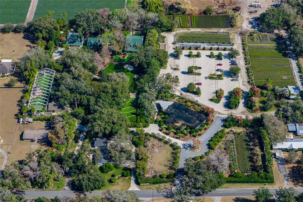 An aerial view shows a large property with multiple buildings, a parking lot, and gardens — 3515 GALLAGHER ROAD, DOVER, FL