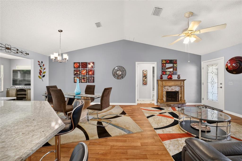 A single-story house with a two-car garage, a concrete driveway, and a palm tree — 1563 HOLLYBERRY PLACE, THE VILLAGES, FL