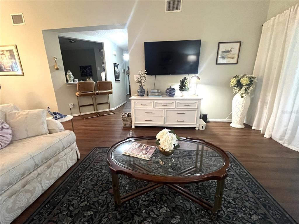 A dining area features a round table, four upholstered chairs, and a chandelier — 413 EAGLE RIDGE DRIVE UNIT 413, DAVENPORT, FL