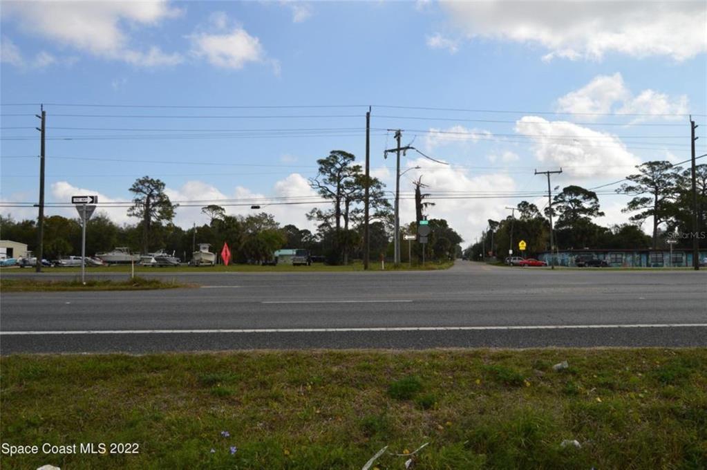 A view of a paved road intersection with power lines and trees in the background — 3500 US HIGHWAY 1, MIMS, FL