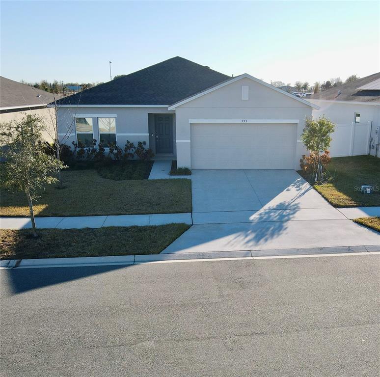 A single-story suburban house with a gray exterior, a two-car garage, and a paved driveway — 993 CALICO POINTE CIRCLE, GROVELAND, FL