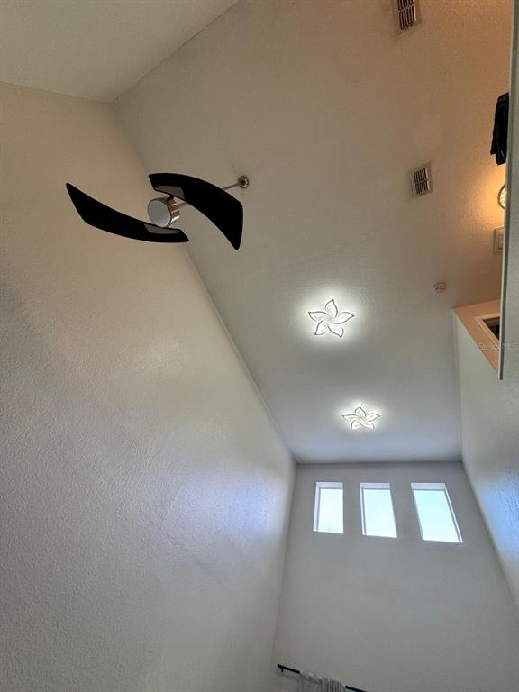 A high-ceilinged room features a modern ceiling fan and two flower-shaped flush-mount light fixtures — 1609 CROYDON STREET, ORLANDO, FL