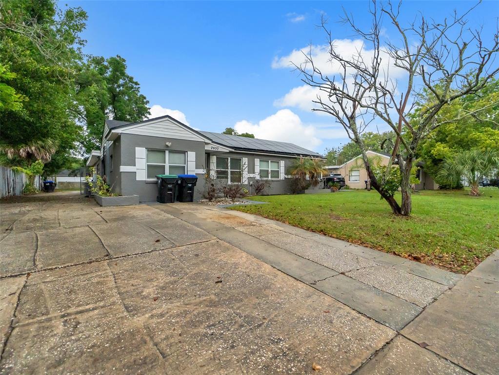 A gray single-story house with a concrete driveway and solar panels on the roof — 2600 EUSTON ROAD, WINTER PARK, FL