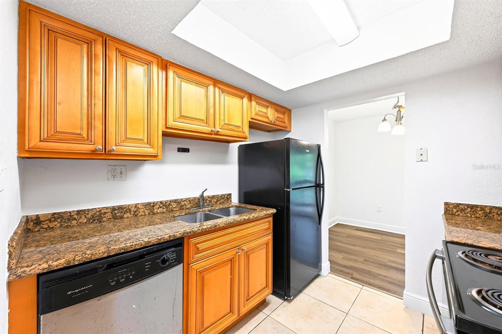 An entryway with a white door, a louvered closet, and a doorway leading to a room — 4737 S TEXAS AVENUE UNIT 4737D, ORLANDO, FL