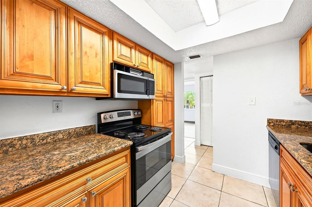 An empty room features wood-look flooring, white walls, and a sliding glass door to a balcony — 4737 S TEXAS AVENUE UNIT 4737D, ORLANDO, FL