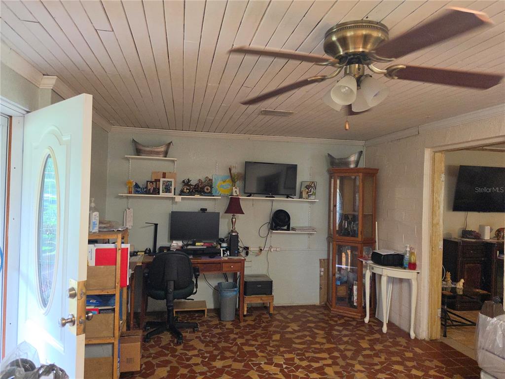 A home office features a desk, shelving, a ceiling fan, and patterned tile flooring — 515 N 3RD STREET, LAKE WALES, FL