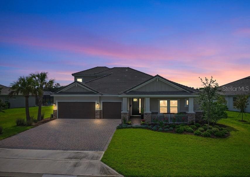 A single-story house with a paved driveway, two-car garage, and a landscaped front yard — 1369 ARKLOW CIRCLE, ORMOND BEACH, FL