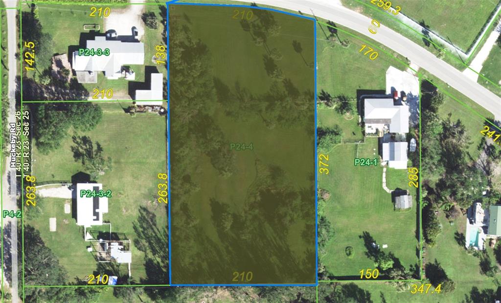 This is an aerial map showing a rectangular parcel of land highlighted in green — 7215 RIVERSIDE  DR., PUNTA GORDA, FL