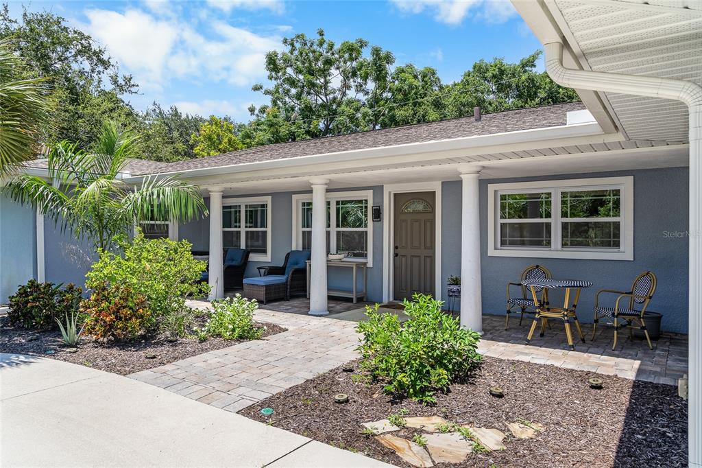 A blue house with a covered porch, white columns, and a paved walkway — 771 INDIAN BEACH CIRCLE, SARASOTA, FL