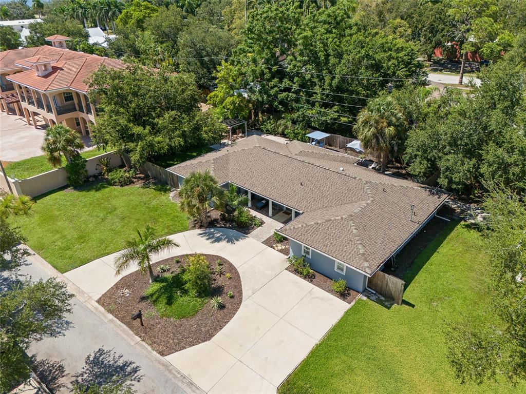 An aerial view shows a single-story house with a shingled roof and a circular driveway — 771 INDIAN BEACH CIRCLE, SARASOTA, FL