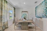 A dining room features a rectangular table with six chairs, a large mirror, and patterned curtains — 5820 ARBORETUM STREET, ST CLOUD, FL