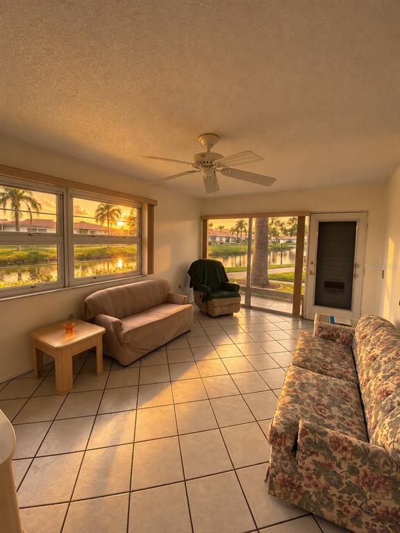 A single-story home with a stone facade, white door, and a stone walkway — 4326 TAHITIAN GARDENS CIRCLE UNIT 14E, HOLIDAY, FL